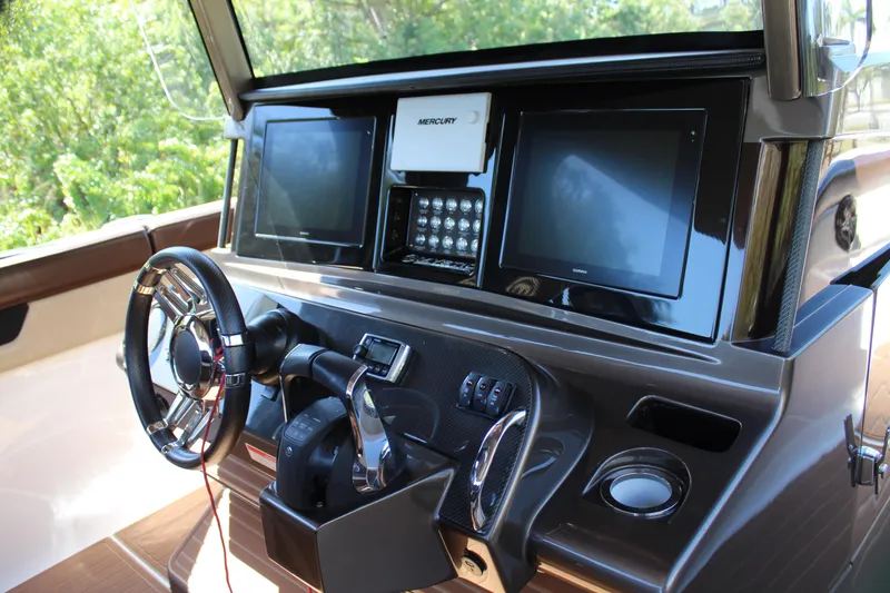 Slide: The Image of 2016 Mystic Powerboats M4200 helm with dual screens and advanced controls. - 29