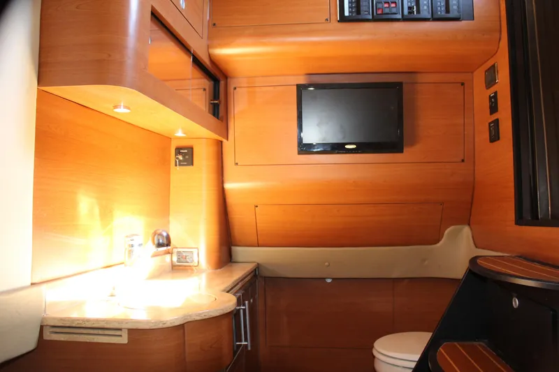 Slide: The Image of 2016 Mystic Powerboats M4200 interior cabin with wooden finish and modern amenities. - 41