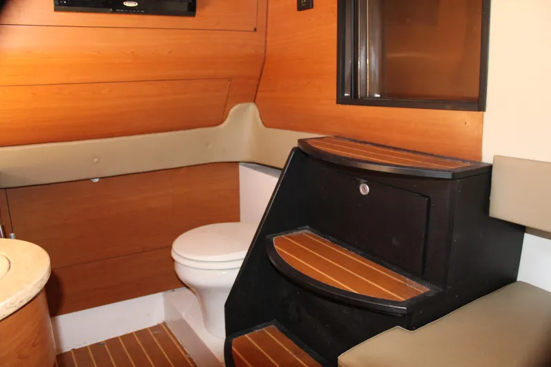 Slide: The Image of 2016 Mystic Powerboats M4200 interior cabin with wooden steps and toilet. - 43