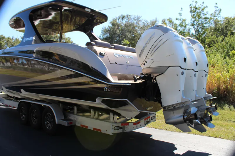 Slide: The Image of 2016 Mystic Powerboats M4200 on trailer with triple outboard engines. - 7