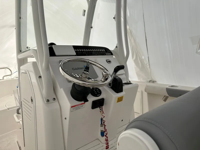 Slide: The Image of 2018 Everglades 230CC boat console with Garmin navigation system and steering wheel. - 1