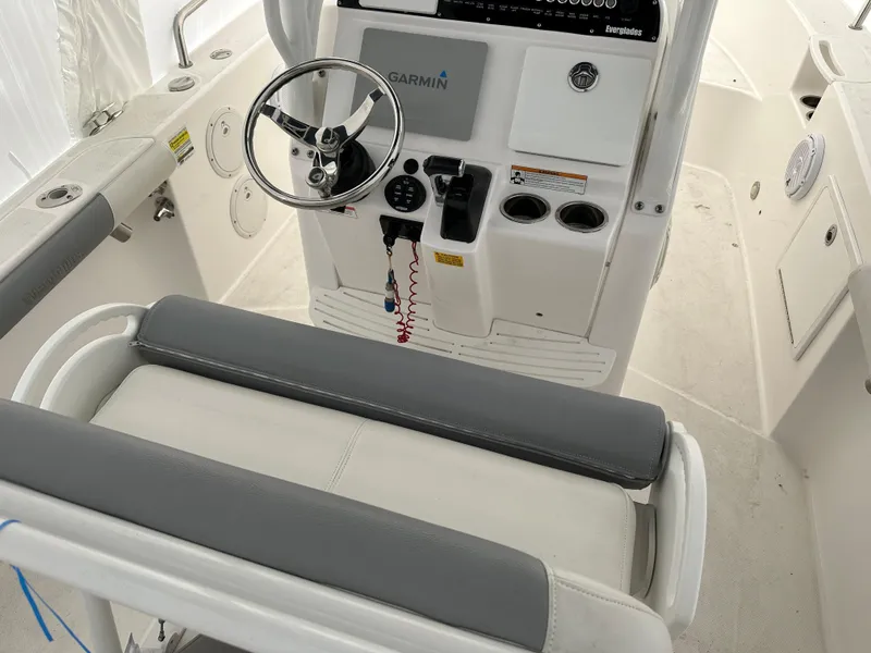 Slide: The Image of 2018 Everglades 230CC boat helm with Garmin navigation system and cushioned seating. - 10