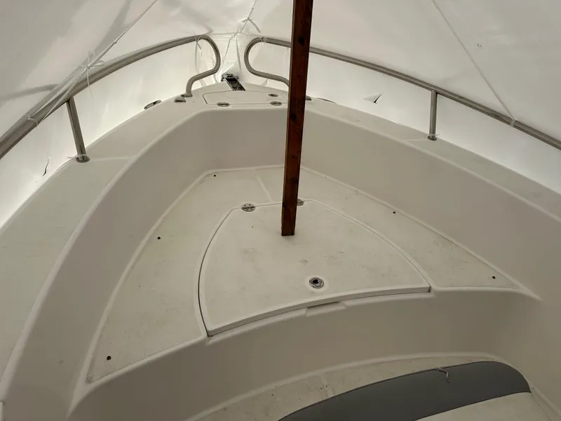 Slide: The Image of 2018 Everglades 230CC boat interior under cover, showing bow seating and storage. - 3