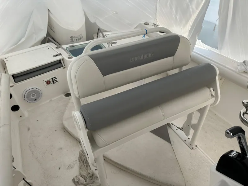 Slide: The Image of 2018 Everglades 230CC boat interior with cushioned seating and control panel. - 7