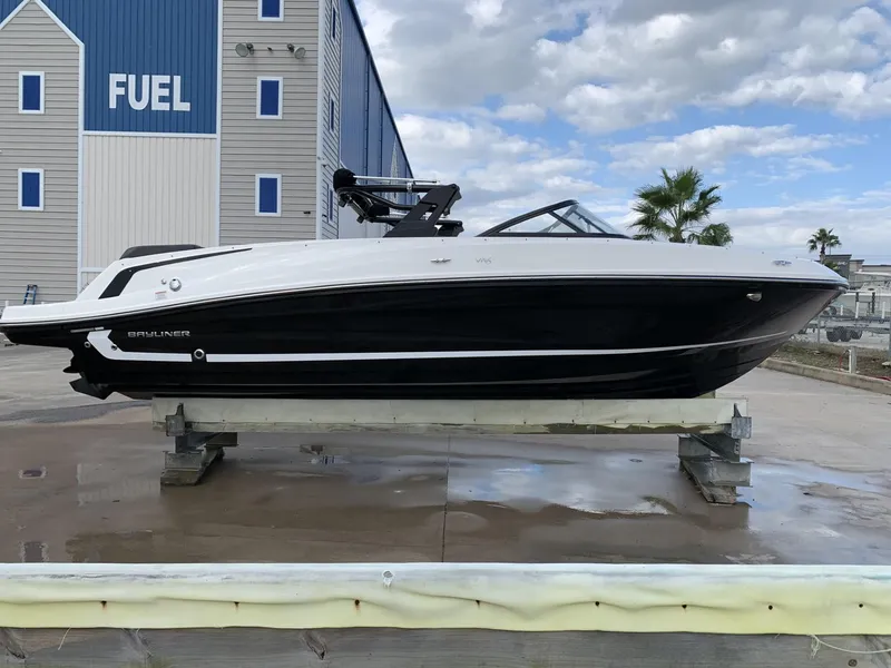 The Image of 2020 Bayliner VR6 Bowrider I/O boat on display near a fuel station. - 0