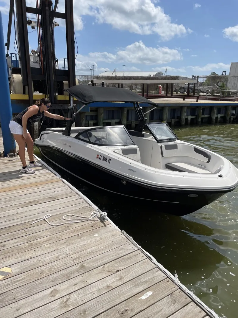 Slide: The Image of 2020 Bayliner VR6 Bowrider I/O docked at a marina on a sunny day. - 4