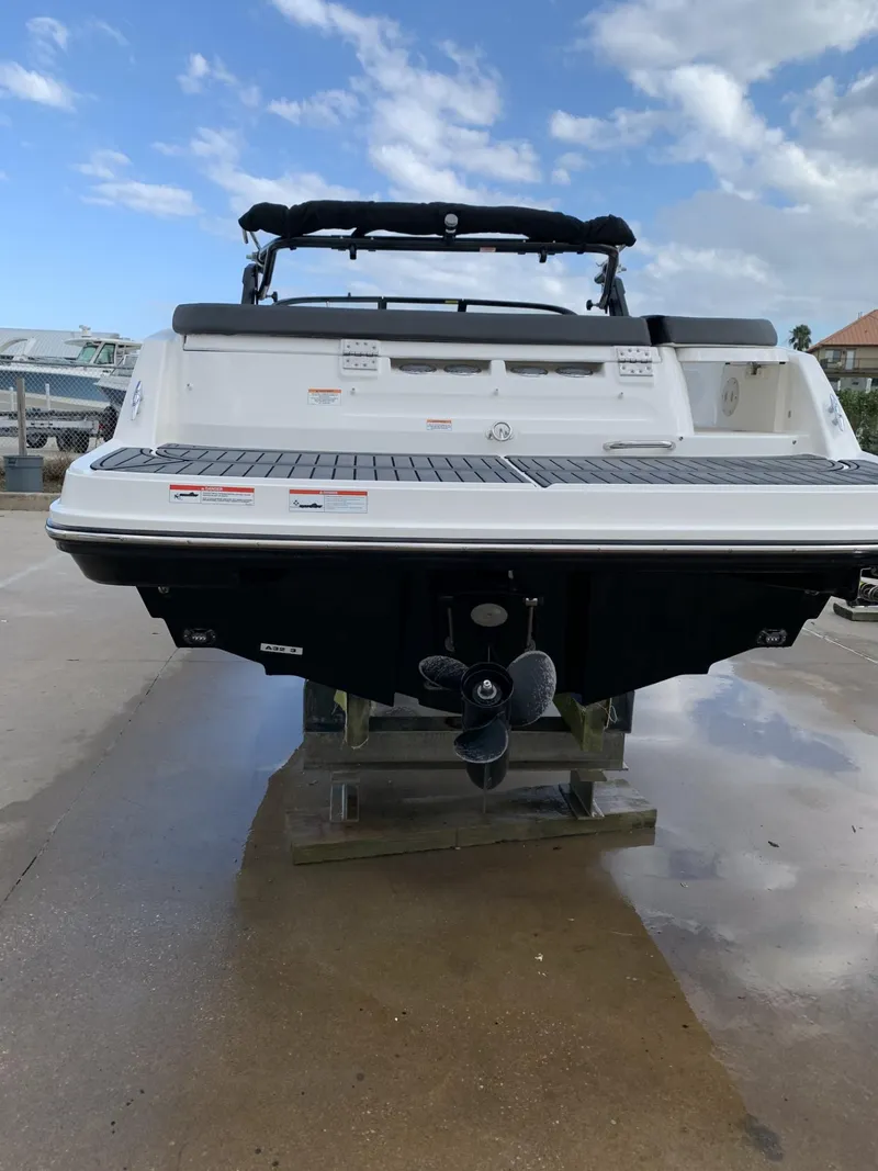 Slide: The Image of 2020 Bayliner VR6 Bowrider I/O boat rear view on a dock. - 5