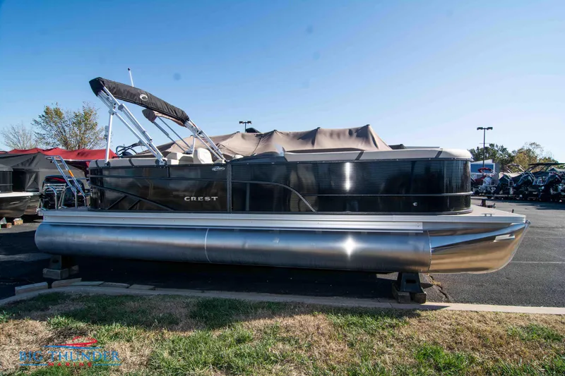 The Image of 2024 Crest Classic DLX 240 SLC pontoon boat in a parking lot. - 0