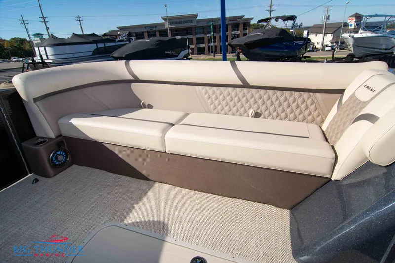 Slide: The Image of 2024 Crest Classic DLX 240 SLC boat interior with beige seating and diamond-patterned upholstery. - 11