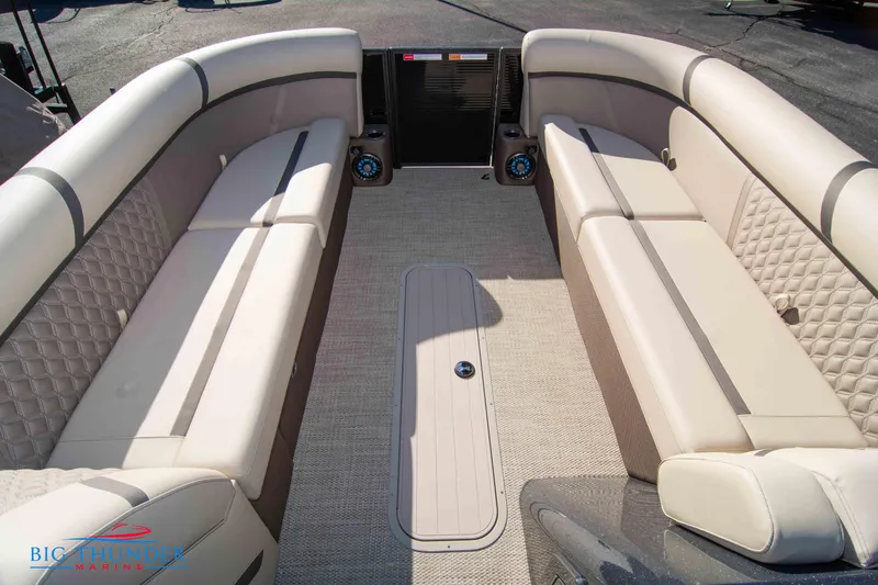 Slide: The Image of 2024 Crest Classic DLX 240 SLC pontoon boat interior with beige seating and carpet. - 12