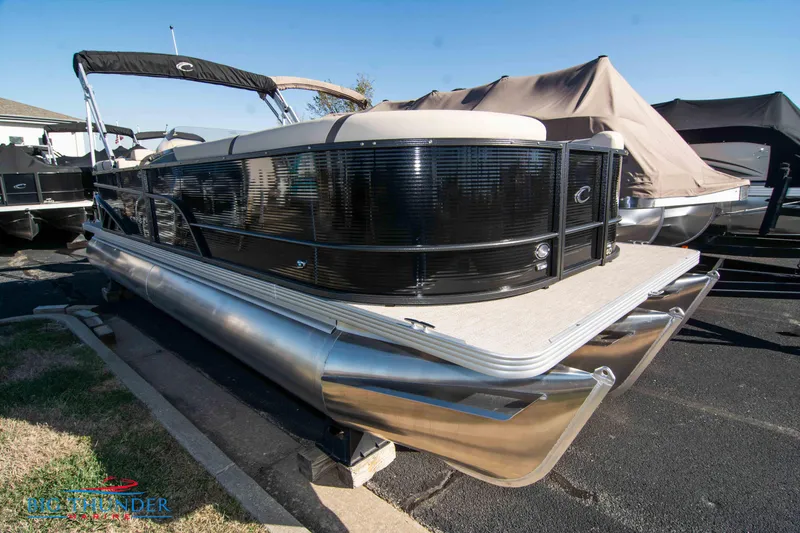 Slide: The Image of 2024 Crest Classic DLX 240 SLC pontoon boat in a showroom. - 2