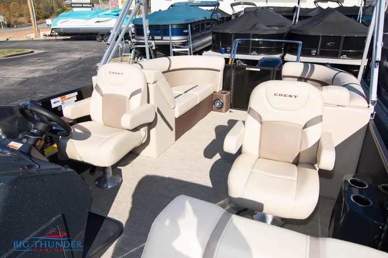 Slide: The Image of 2024 Crest Classic DLX 240 SLC pontoon boat with beige seating and helm. - 23