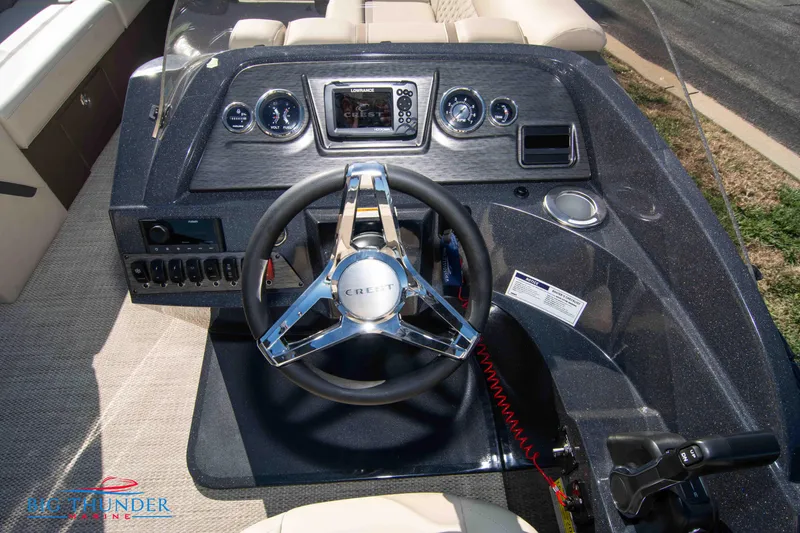 Slide: The Image of 2024 Crest Classic DLX 240 SLC boat dashboard with steering wheel and control panel. - 25