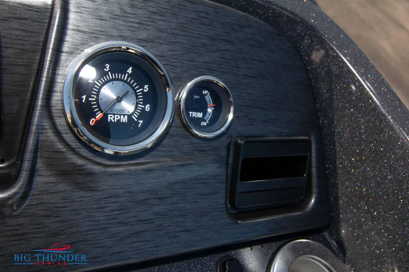 Slide: The Image of Dashboard of 2024 Crest Classic DLX 240 SLC boat with RPM and trim gauges. - 29