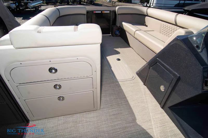 Slide: The Image of Interior of 2024 Crest Classic DLX 240 SLC pontoon boat with beige seating and storage compartments. - 34