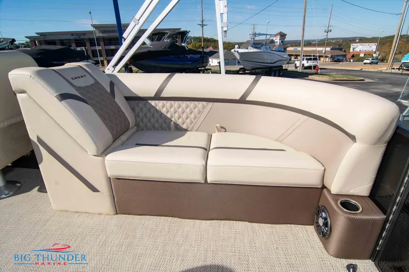 Slide: The Image of 2024 Crest Classic DLX 240 SLC boat interior with beige seating and cup holder. - 37