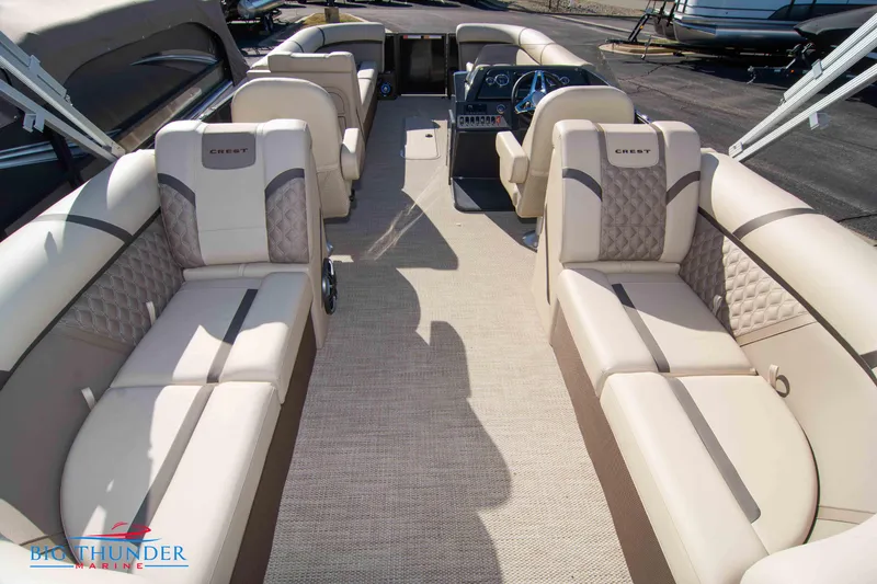 Slide: The Image of 2024 Crest Classic DLX 240 SLC pontoon boat interior with beige seating and modern dashboard. - 38