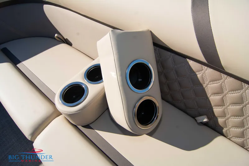 Slide: The Image of 2024 Crest Classic DLX 240 SLC boat interior with cup holders and quilted seats. - 47