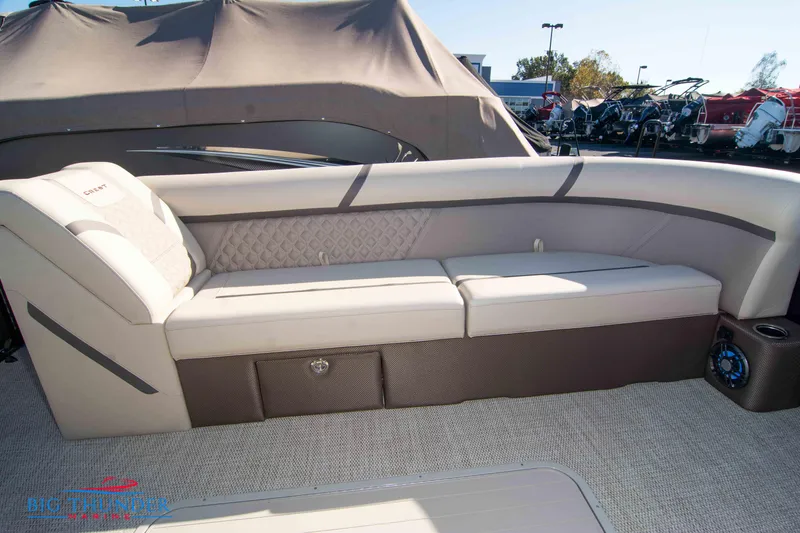 Slide: The Image of 2024 Crest Classic DLX 240 SLC pontoon boat interior with beige seating. - 9