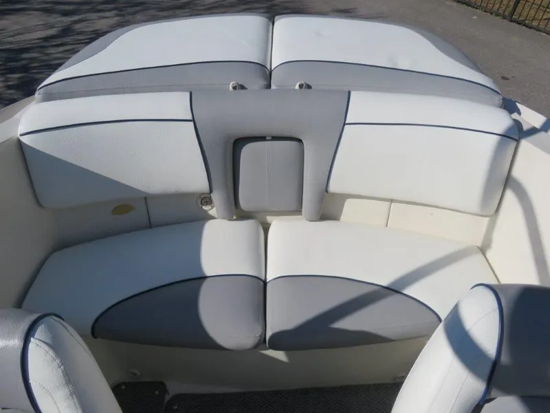Slide: The Image of 2008 Sea Ray 195 Sport boat interior with white and gray seating. - 2