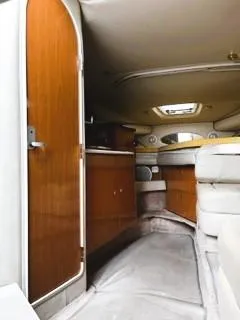 Slide: The Image of Interior of 2001 Regal 2960 Commodore Cruiser with wood accents and cozy seating. - 10