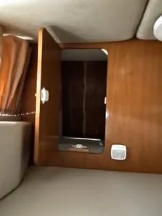 Slide: The Image of 2001 Regal 2960 Commodore Cruiser interior with open wooden cabinet. - 11