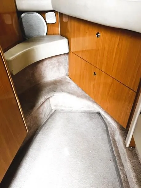 Slide: The Image of 2001 Regal 2960 Commodore Cruiser interior with wood paneling and carpeted flooring. - 18