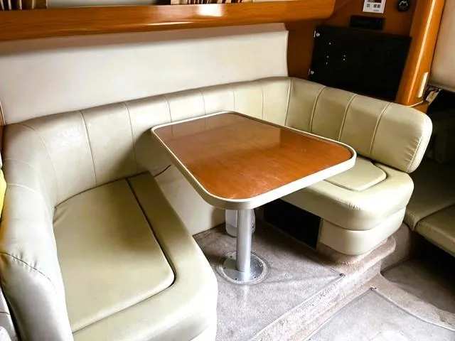 Slide: The Image of 2001 Regal 2960 Commodore Cruiser interior with beige seating and wooden table. - 19