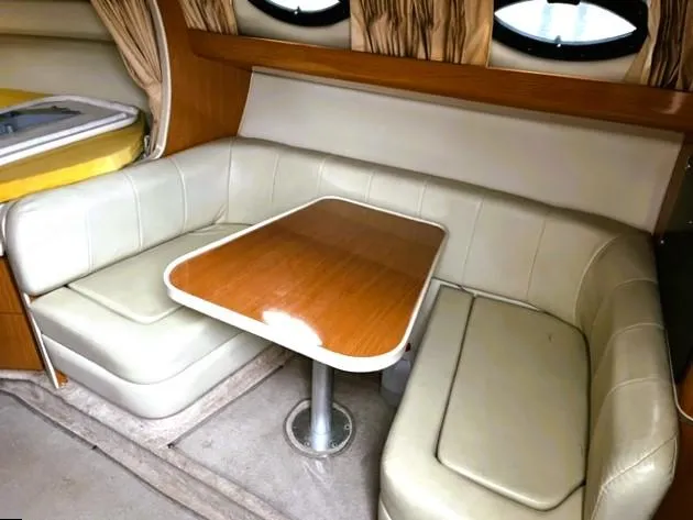 Slide: The Image of 2001 Regal 2960 Commodore Cruiser interior with beige seating and wooden table. - 20