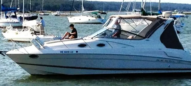 Slide: The Image of 2001 Regal 2960 Commodore Cruiser on water with people aboard, surrounded by other boats. - 21