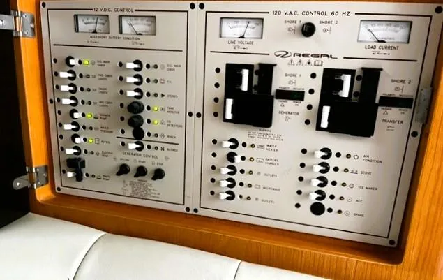 Slide: The Image of Control panel of a 2001 Regal 2960 Commodore Cruiser, featuring various switches and gauges. - 23