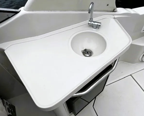 Slide: The Image of 2001 Regal 2960 Commodore Cruiser sink and faucet on white countertop. - 34