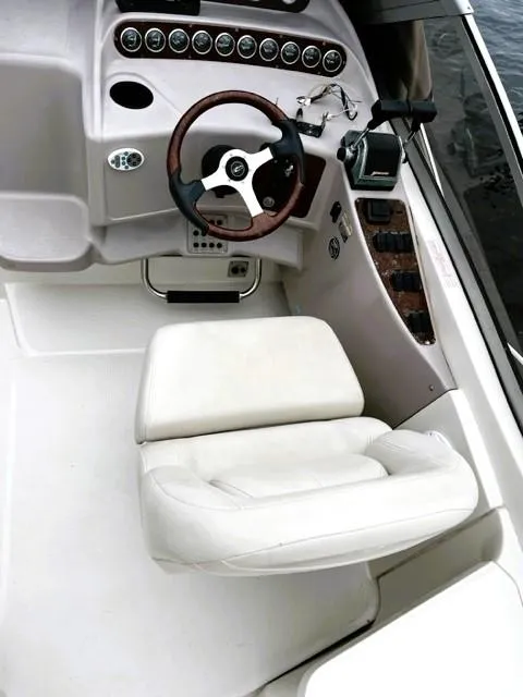 Slide: The Image of 2001 Regal 2960 Commodore Cruiser cockpit with white seating and control panel. - 36