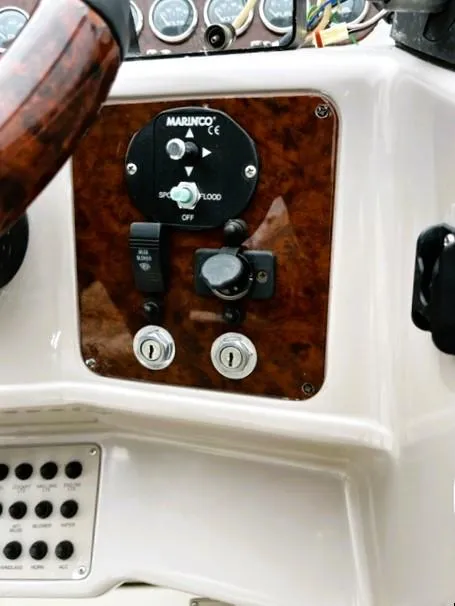Slide: The Image of Control panel of a 2001 Regal 2960 Commodore Cruiser with wood finish and switches. - 39