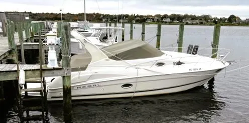 Slide: The Image of 2001 Regal 2960 Commodore Cruiser docked at a marina. - 4