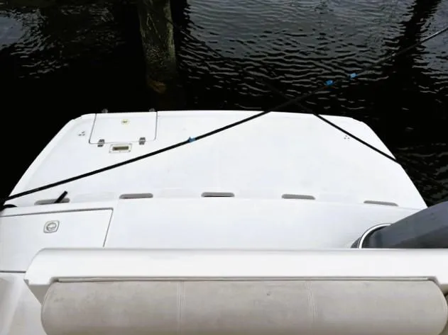 Slide: The Image of 2001 Regal 2960 Commodore Cruiser's deck, moored on calm water. - 43