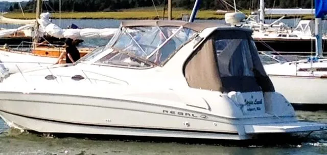 Slide: The Image of 2001 Regal 2960 Commodore Cruiser boat docked in a marina. - 5