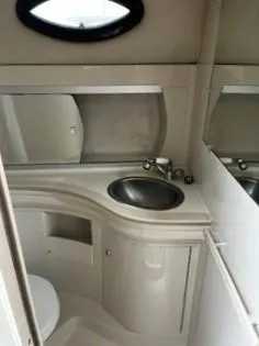 Slide: The Image of 2001 Regal 2960 Commodore Cruiser bathroom with sink and mirror. - 7