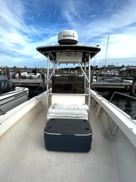 Slide: The Image of 1995 Parker 210 boat docked at marina under blue sky. - 4