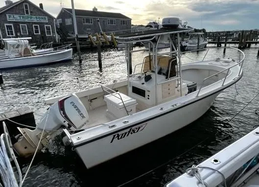 Slide: The Image of 1995 Parker 210 boat docked at marina with Evinrude outboard motor. - 7