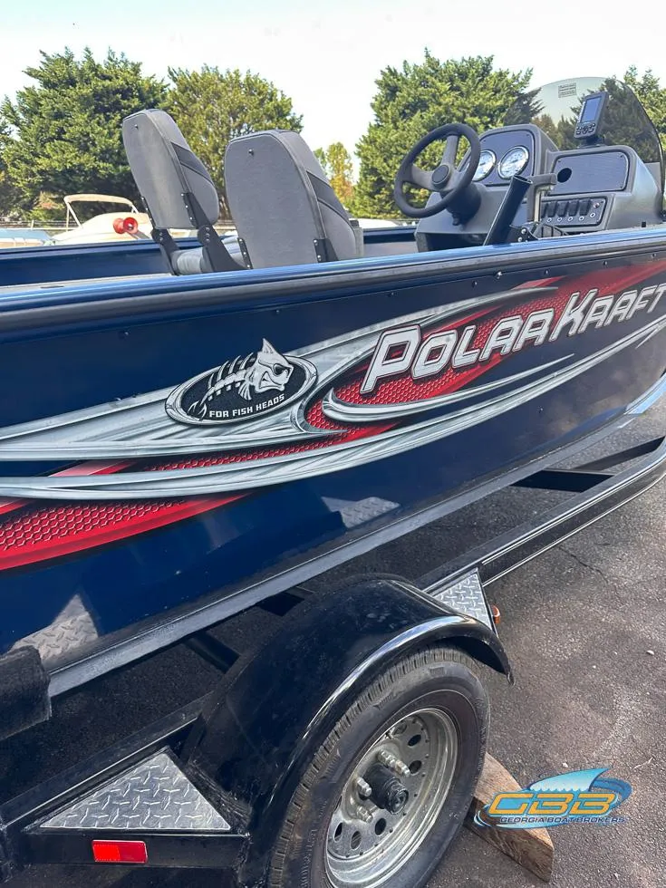Slide: The Image of 2015 Polar Kraft Outlander 186 SC boat side view with logo and trailer. - 16