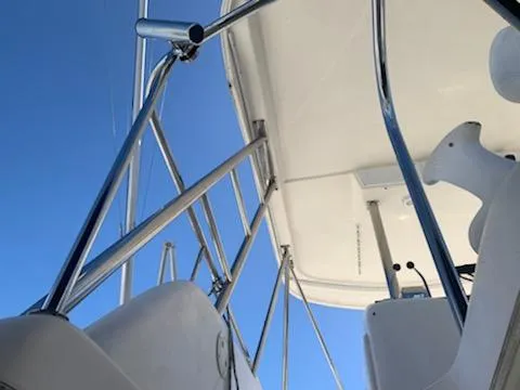 Slide: The Image of View of the upper deck and railing of a 2000 Riviera 34 Convertible boat. - 14