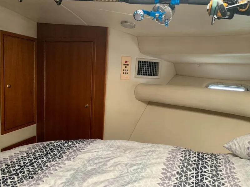 Slide: The Image of Interior cabin of 2000 Riviera 34 Convertible with bed and wooden door. - 27