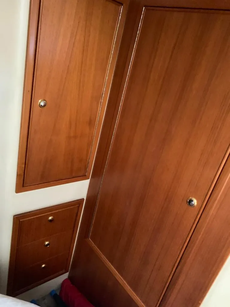 Slide: The Image of Wooden cabinetry inside 2000 Riviera 34 Convertible boat. - 28