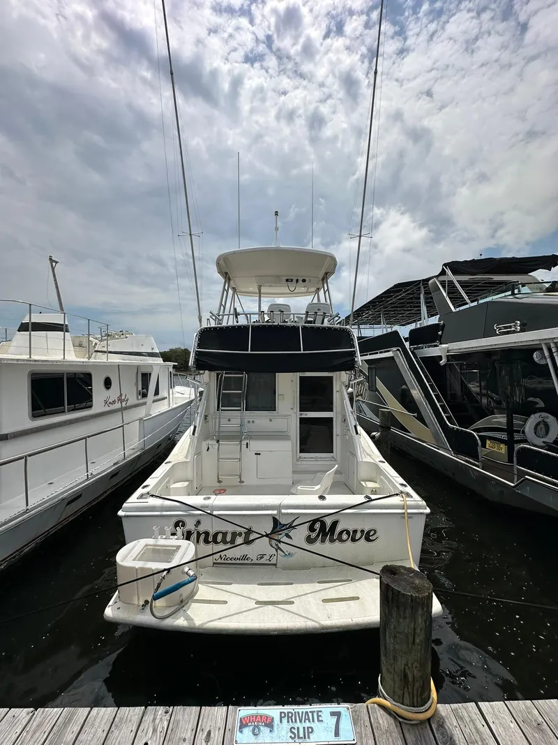 Slide: The Image of 2000 Riviera 34 Convertible boat docked at a private slip. - 3