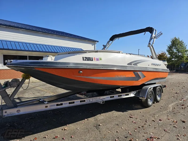 Slide: The Image of 2018 Starcraft Star Step 221 I/O boat on a trailer in a parking lot. - 11