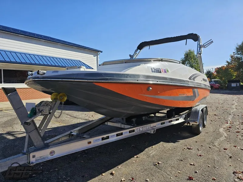 Slide: The Image of 2018 Starcraft Star Step 221 I/O boat on a trailer in a parking lot. - 12