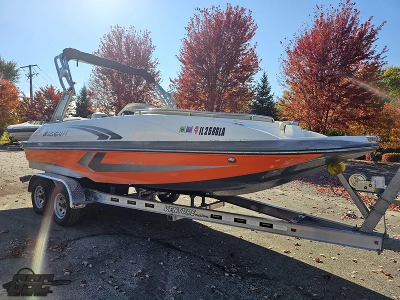 Slide: The Image of 2018 Starcraft Star Step 221 I/O boat on a trailer, autumn background. - 14