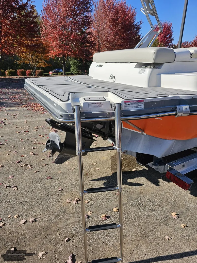 Slide: The Image of 2018 Starcraft Star Step 221 I/O boat with rear ladder and autumn foliage. - 24