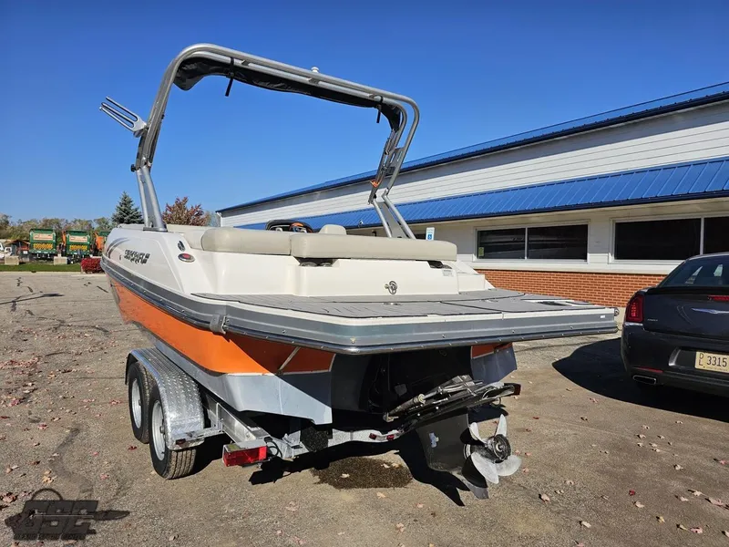 Slide: The Image of 2018 Starcraft Star Step 221 I/O boat on a trailer in a parking lot. - 25